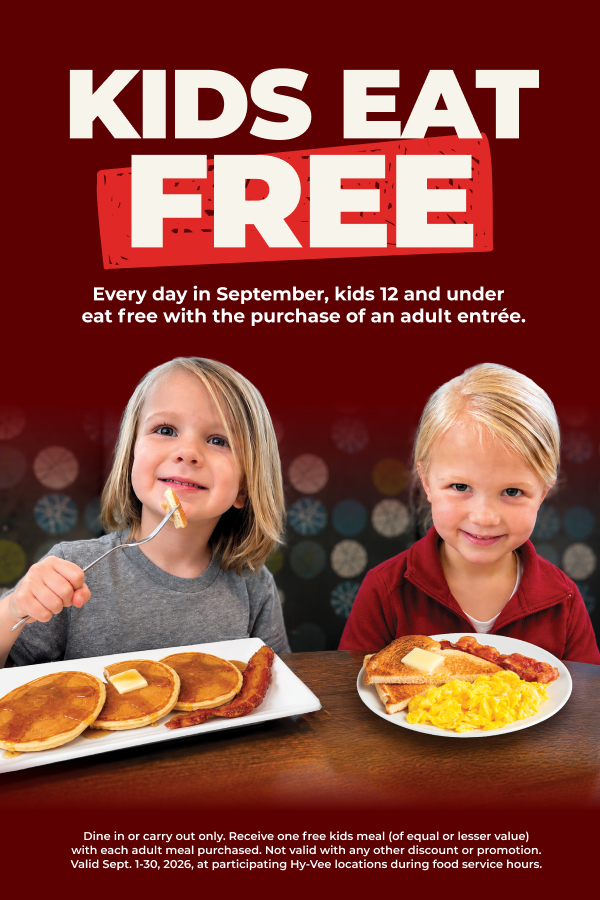 Kids Eat Free — every day in September, kids 12 and under eat free with an adult entrée purchase. Two kids with pancakes, eggs and bacon.